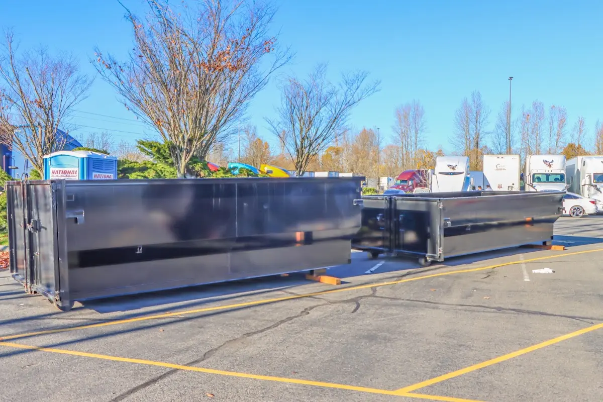 Professional dumpster rental service with roll-off container on residential driveway in Gulfport